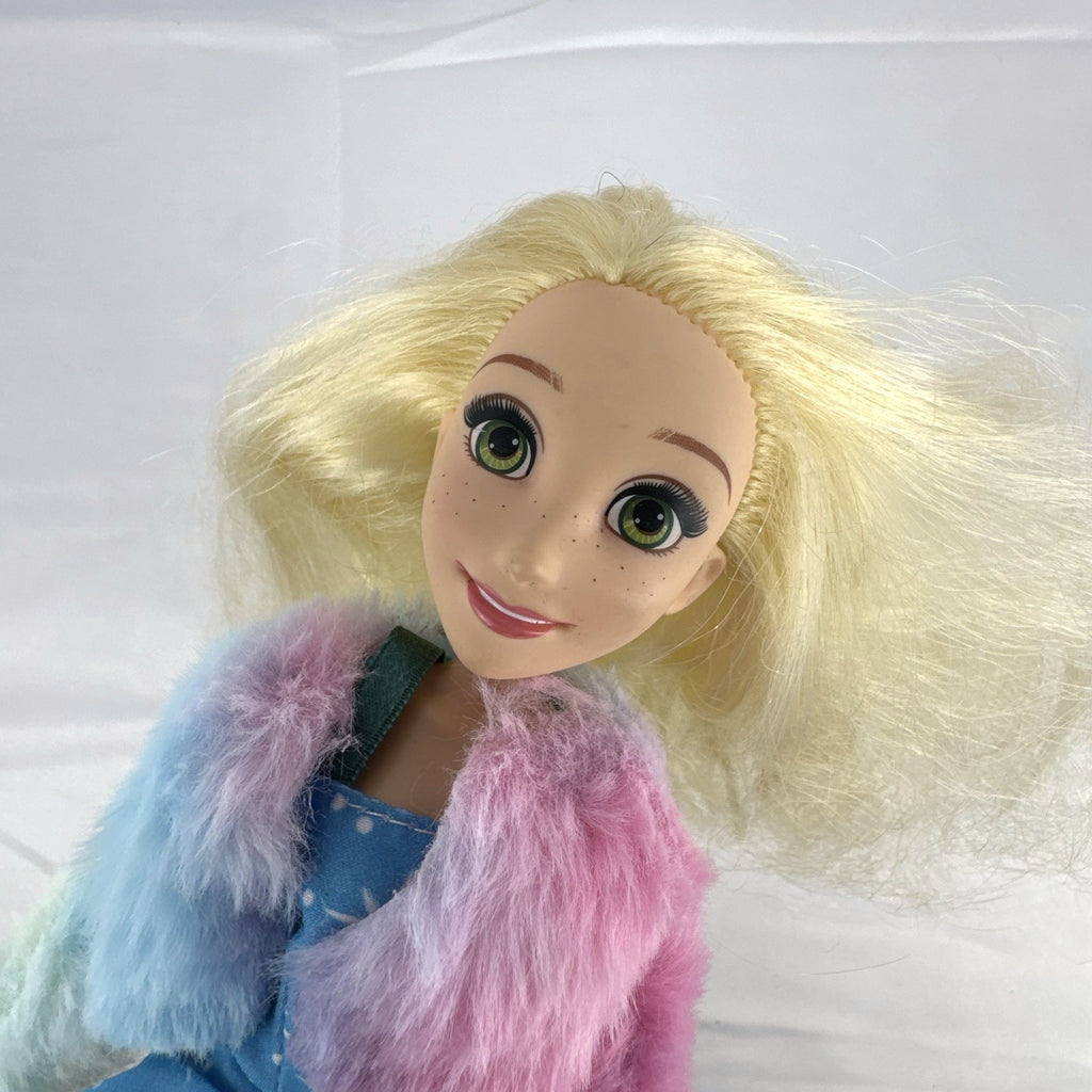 Disney Tangled Rapunzel 11-inch fashion doll wearing blue star dress and pastel faux fur jacket
