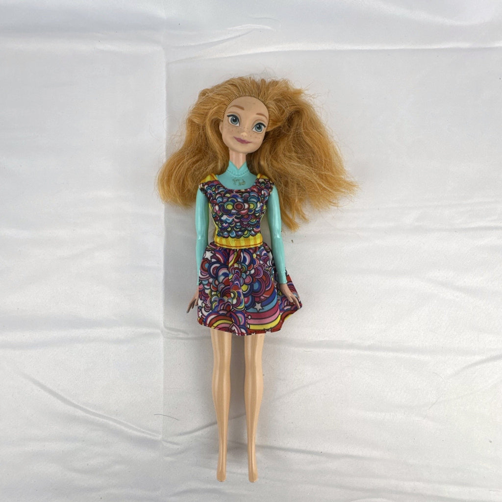 Mattel 11.5-inch Disney Frozen Princess Anna fashion doll wearing patterned dress with strawberry-blonde hair