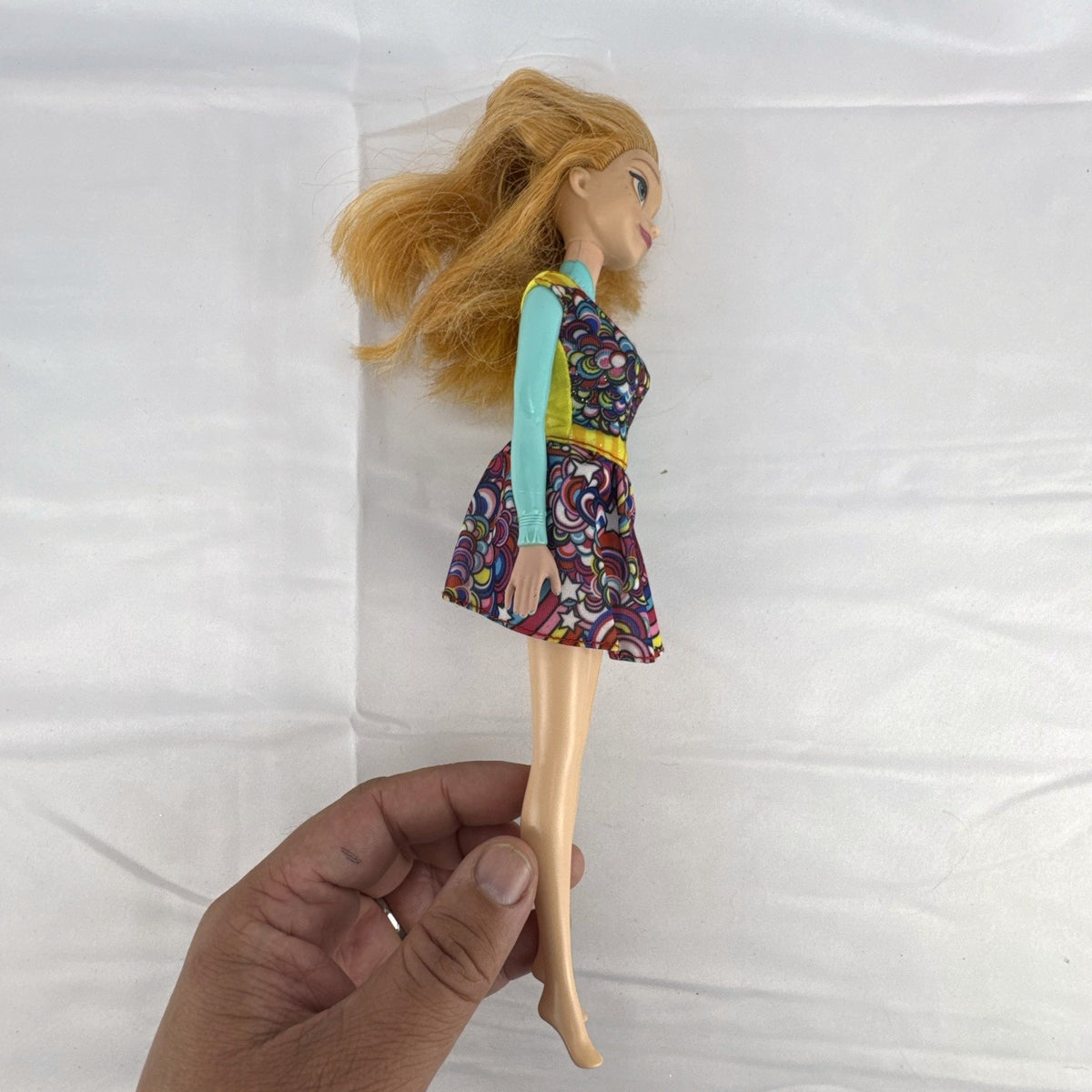 Mattel 11.5-inch Disney Frozen Princess Anna fashion doll wearing patterned dress with strawberry-blonde hair