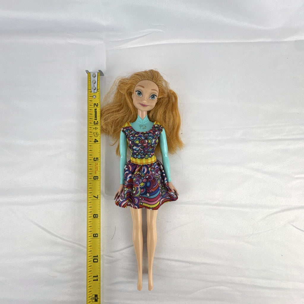 Mattel 11.5-inch Disney Frozen Princess Anna fashion doll wearing patterned dress with strawberry-blonde hair