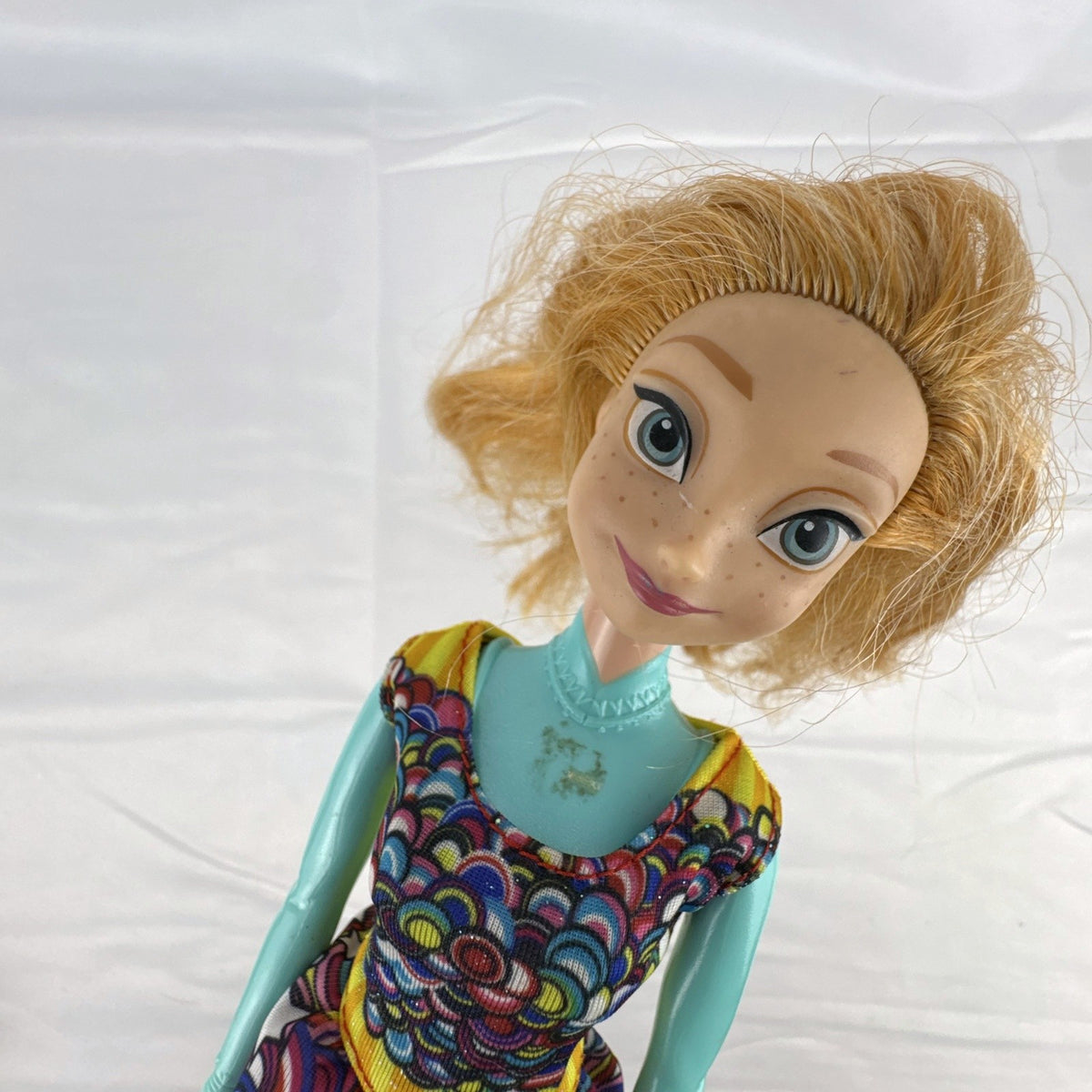 Mattel 11.5-inch Disney Frozen Princess Anna fashion doll wearing patterned dress with strawberry-blonde hair
