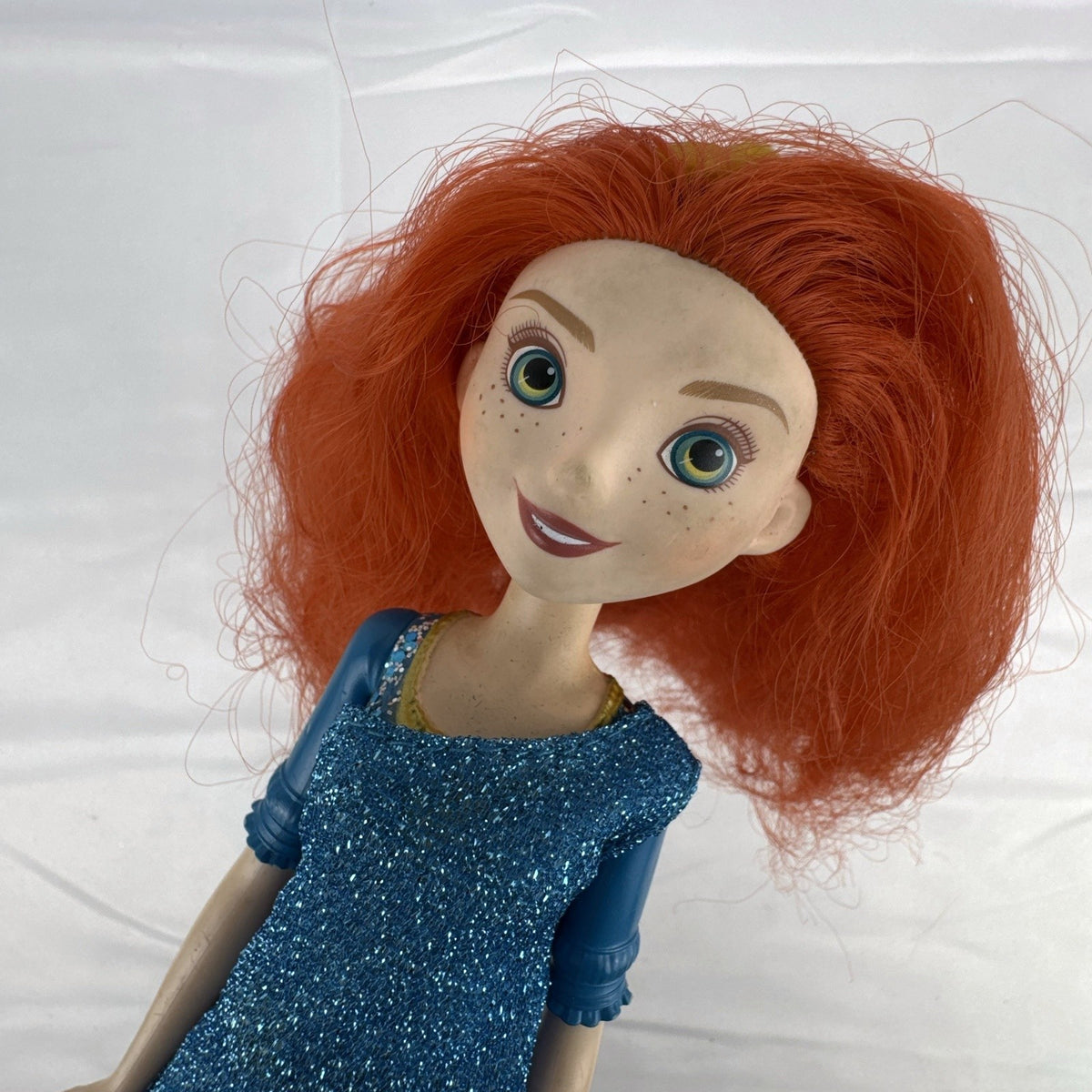 Mattel Disney Pixar Brave Merida 11-inch fashion doll with curly red hair and blue glitter dress