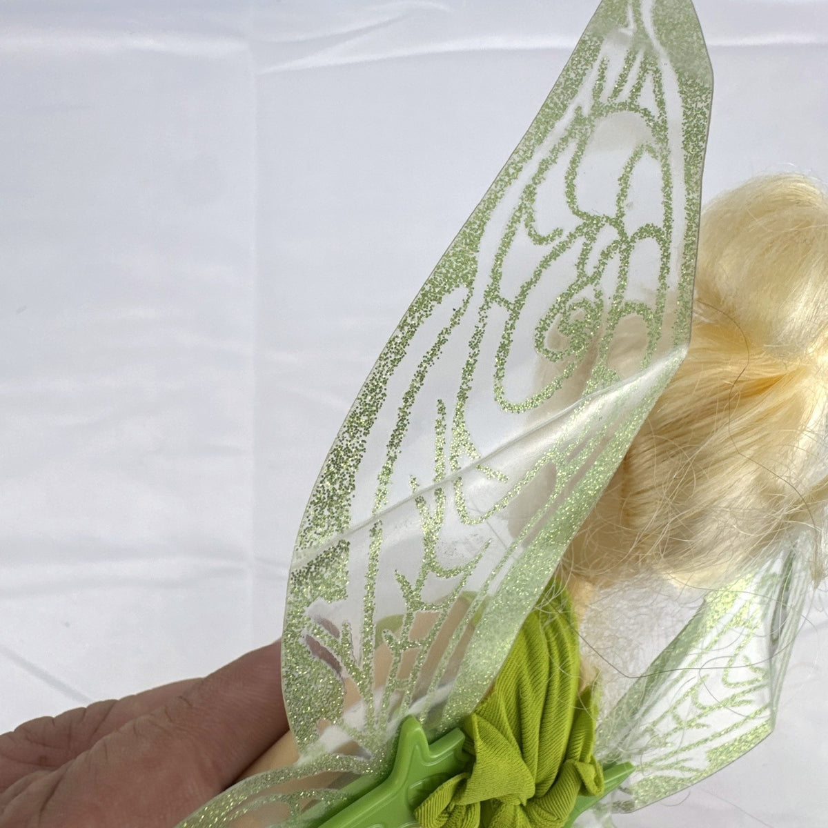 Disney Fairies Tinker Bell 9-inch articulated fashion doll with translucent glitter wings.