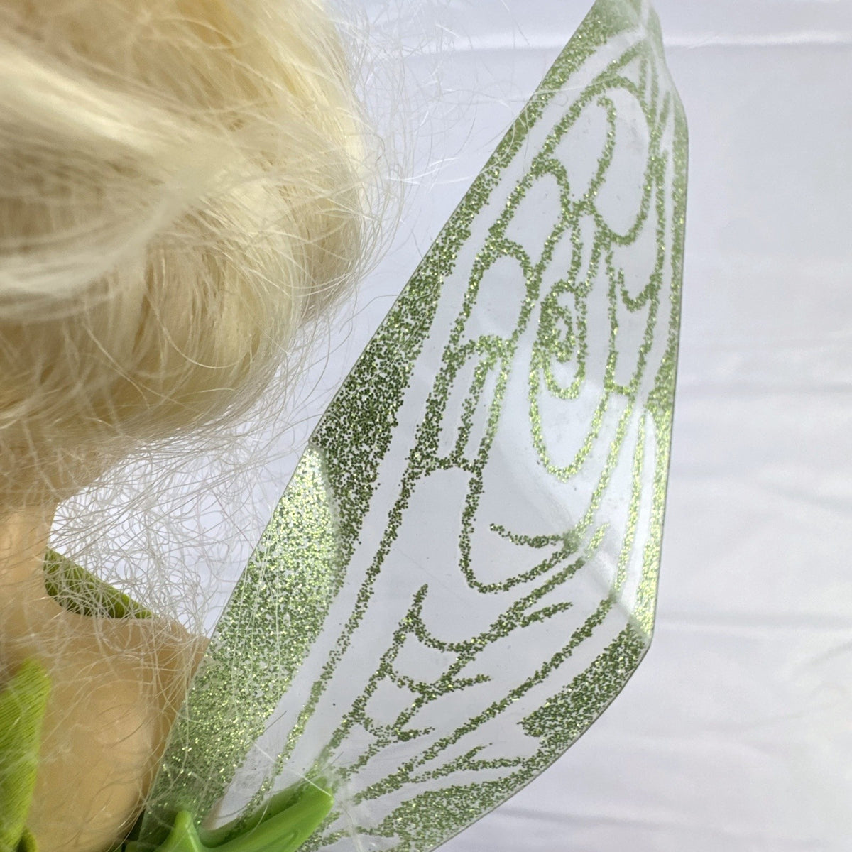 Disney Fairies Tinker Bell 9-inch articulated fashion doll with translucent glitter wings.