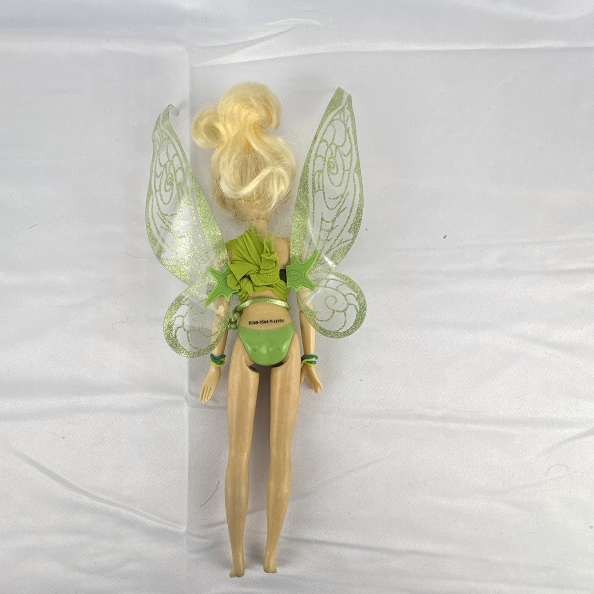 Disney Fairies Tinker Bell 9-inch articulated fashion doll with translucent glitter wings.