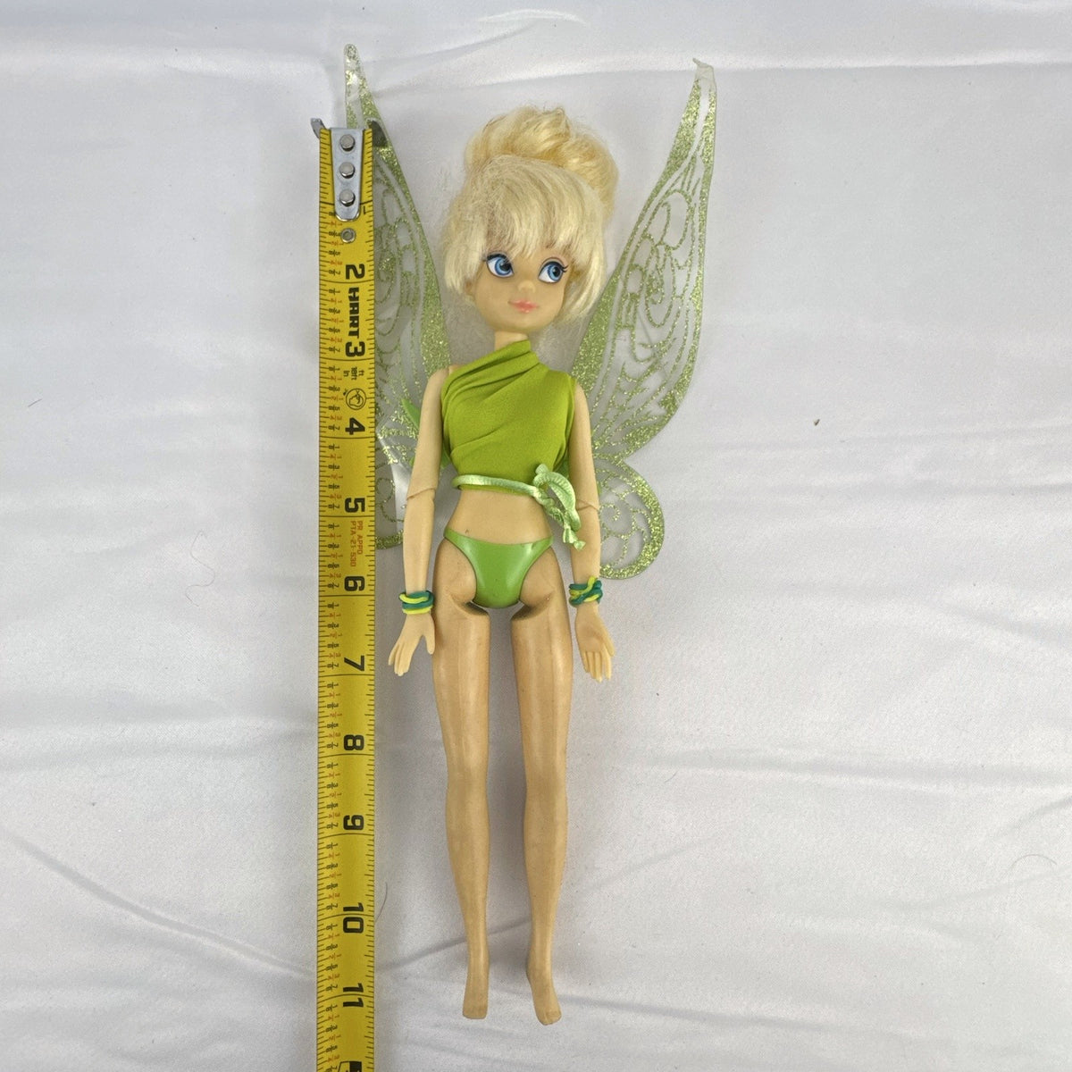 Disney Fairies Tinker Bell 9-inch articulated fashion doll with translucent glitter wings.