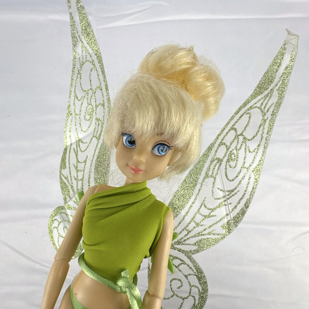 Disney Fairies Tinker Bell 9-inch articulated fashion doll with translucent glitter wings.