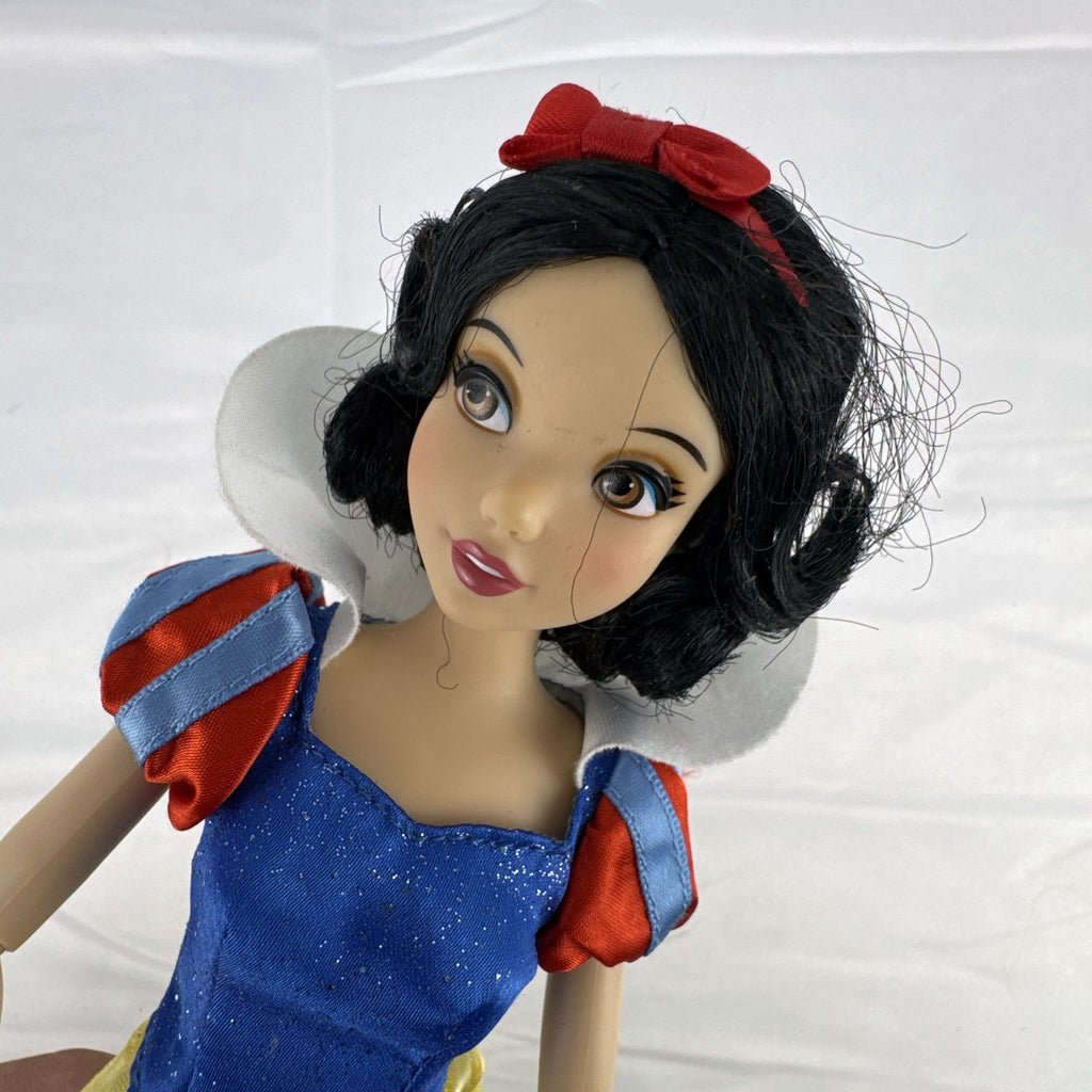 Disney Snow White 11-inch articulated fashion doll in yellow and blue glitter gown