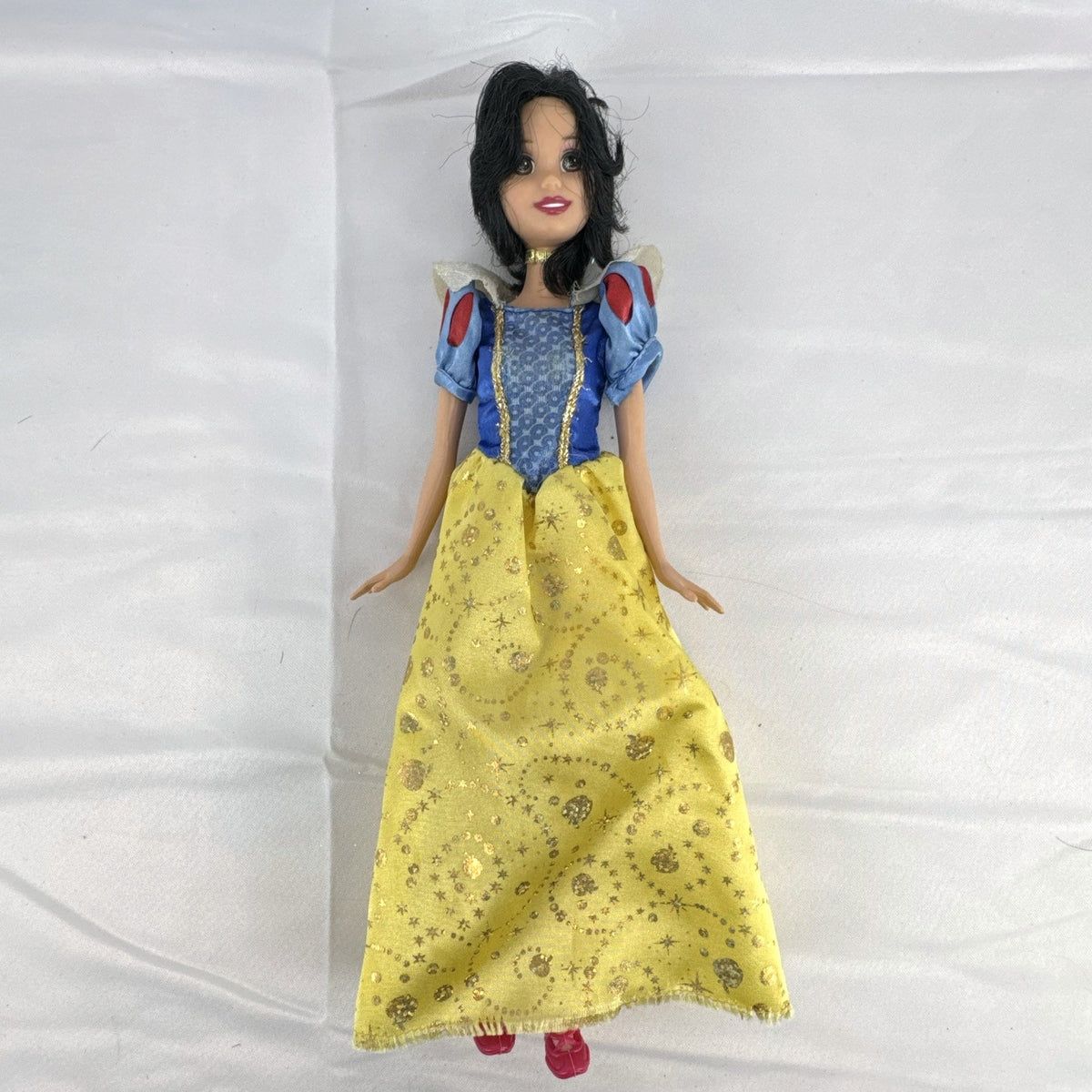 Mattel Disney Princess Snow White 11.5-inch doll wearing signature yellow sparkle gown and red shoes