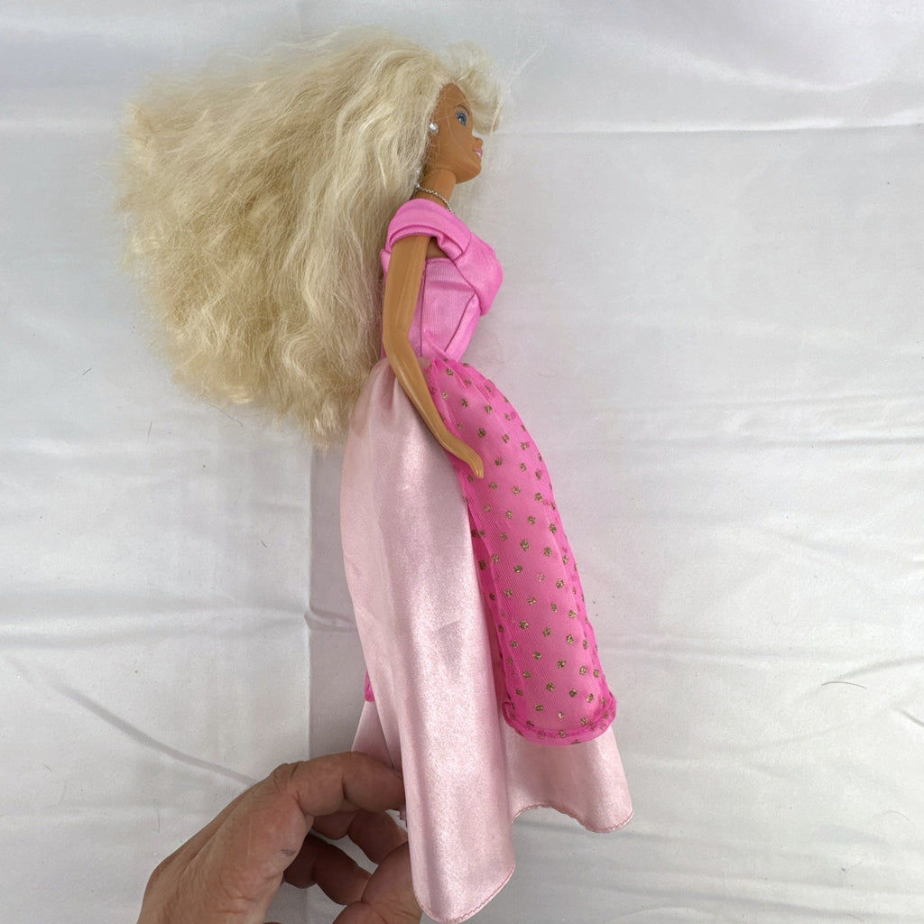 Vintage 1976 Mattel Superstar Barbie doll wearing a layered pink evening gown with jewelry