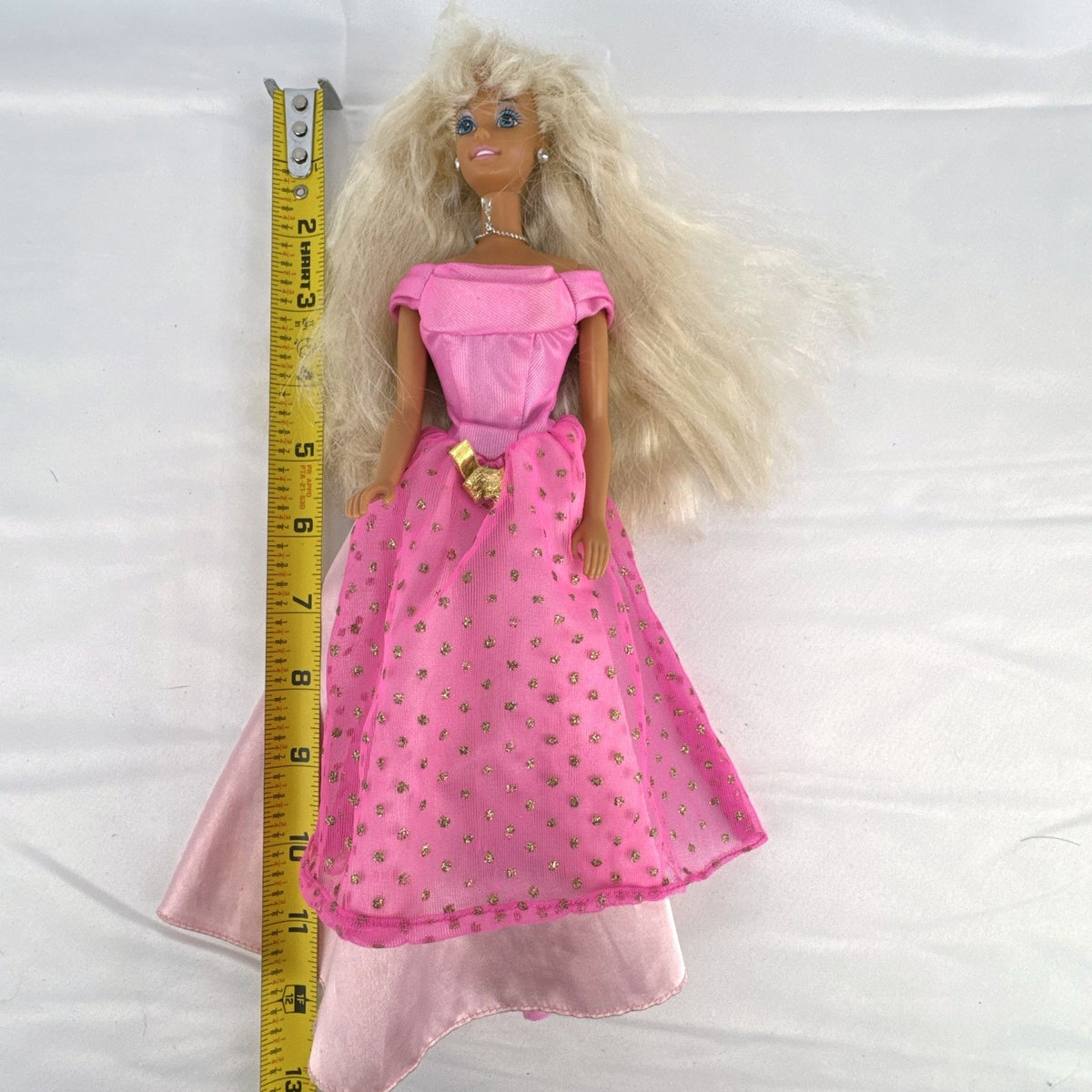 Vintage 1976 Mattel Superstar Barbie doll wearing a layered pink evening gown with jewelry
