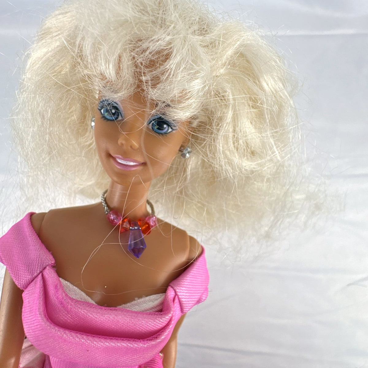 Vintage 1976 Mattel Superstar Barbie doll wearing a layered pink evening gown with jewelry