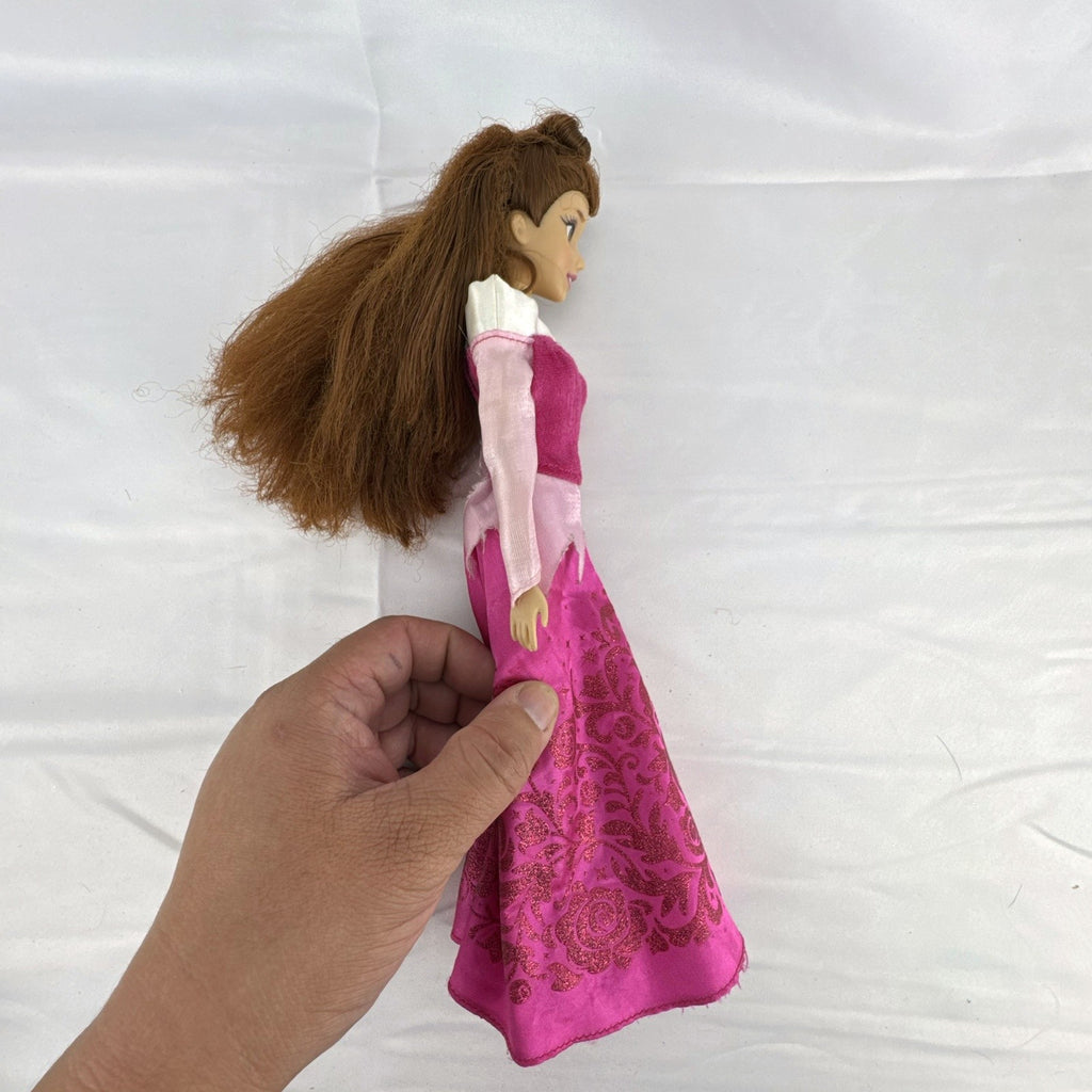 Disney Store 12-inch Belle fashion doll with brown hair wearing a pink and magenta glitter gown