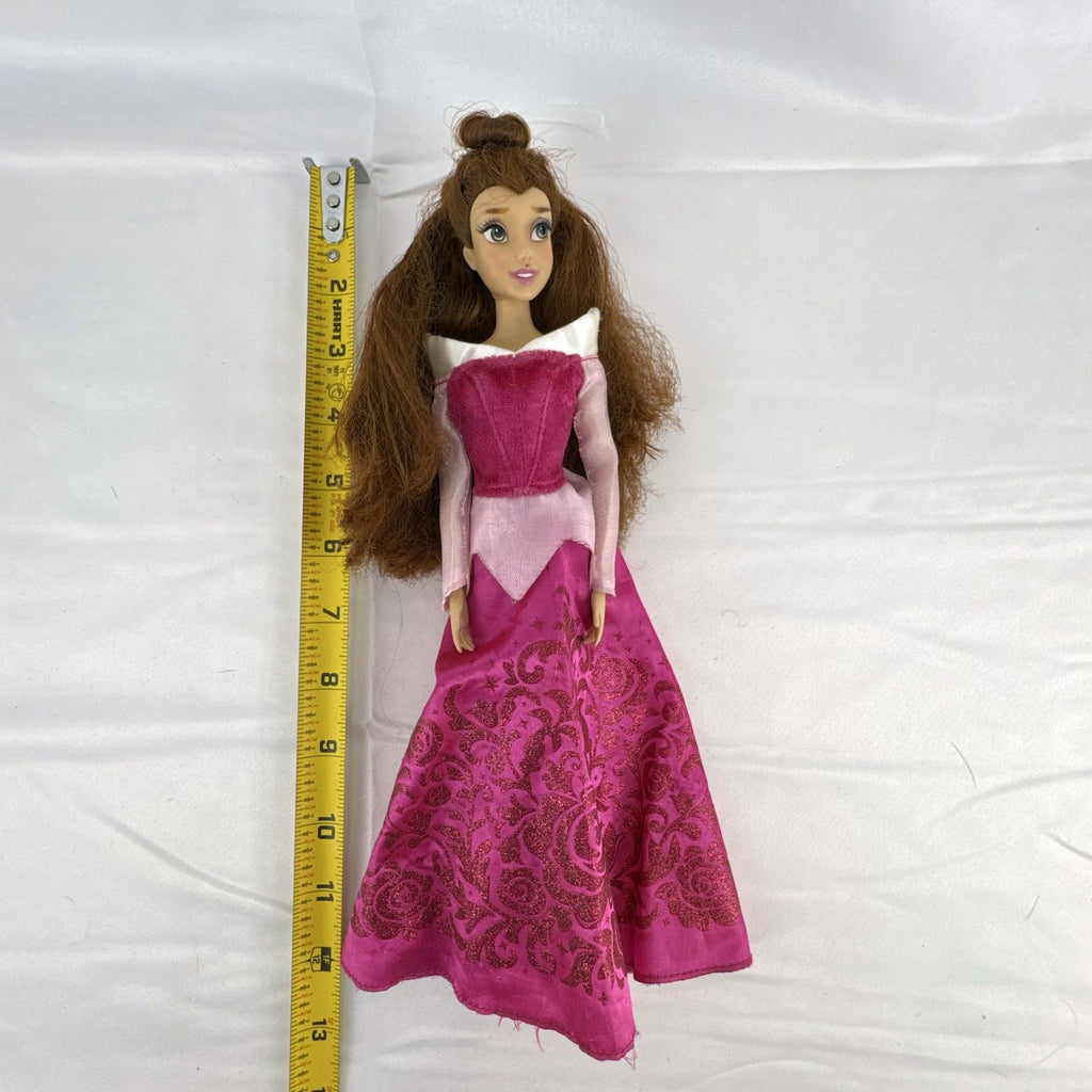 Disney Store 12-inch Belle fashion doll with brown hair wearing a pink and magenta glitter gown