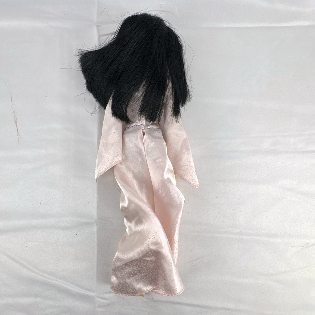 Vintage 12-inch Disney Mulan fashion doll wearing a pink satin matchmaker gown with red and blue sash