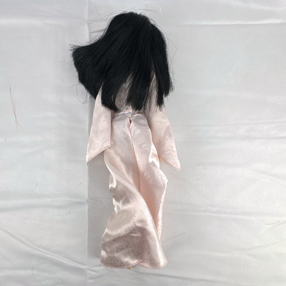 Vintage 12-inch Disney Mulan fashion doll wearing a pink satin matchmaker gown with red and blue sash