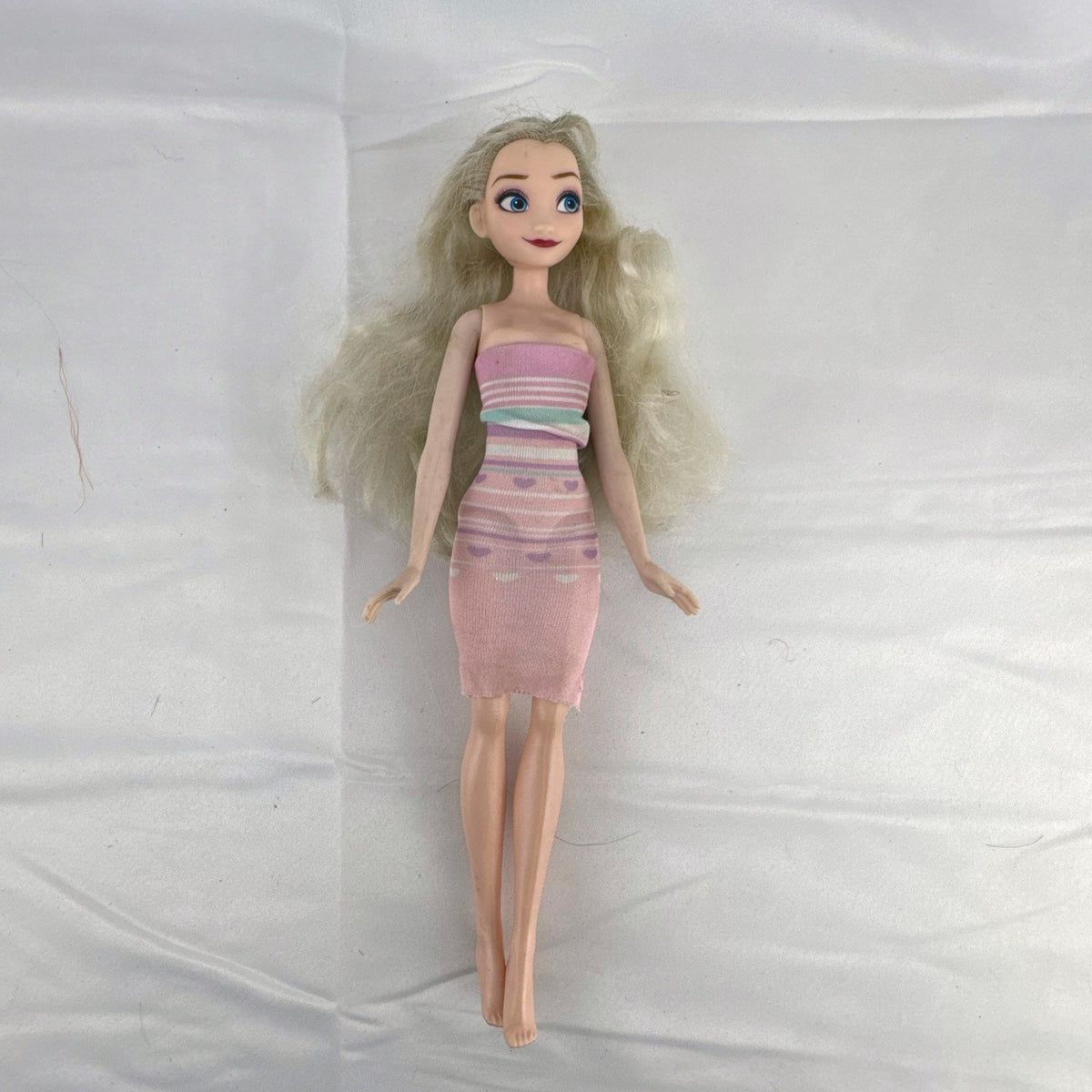Disney Frozen Elsa 11-inch fashion doll with blonde hair wearing a pink striped heart dress