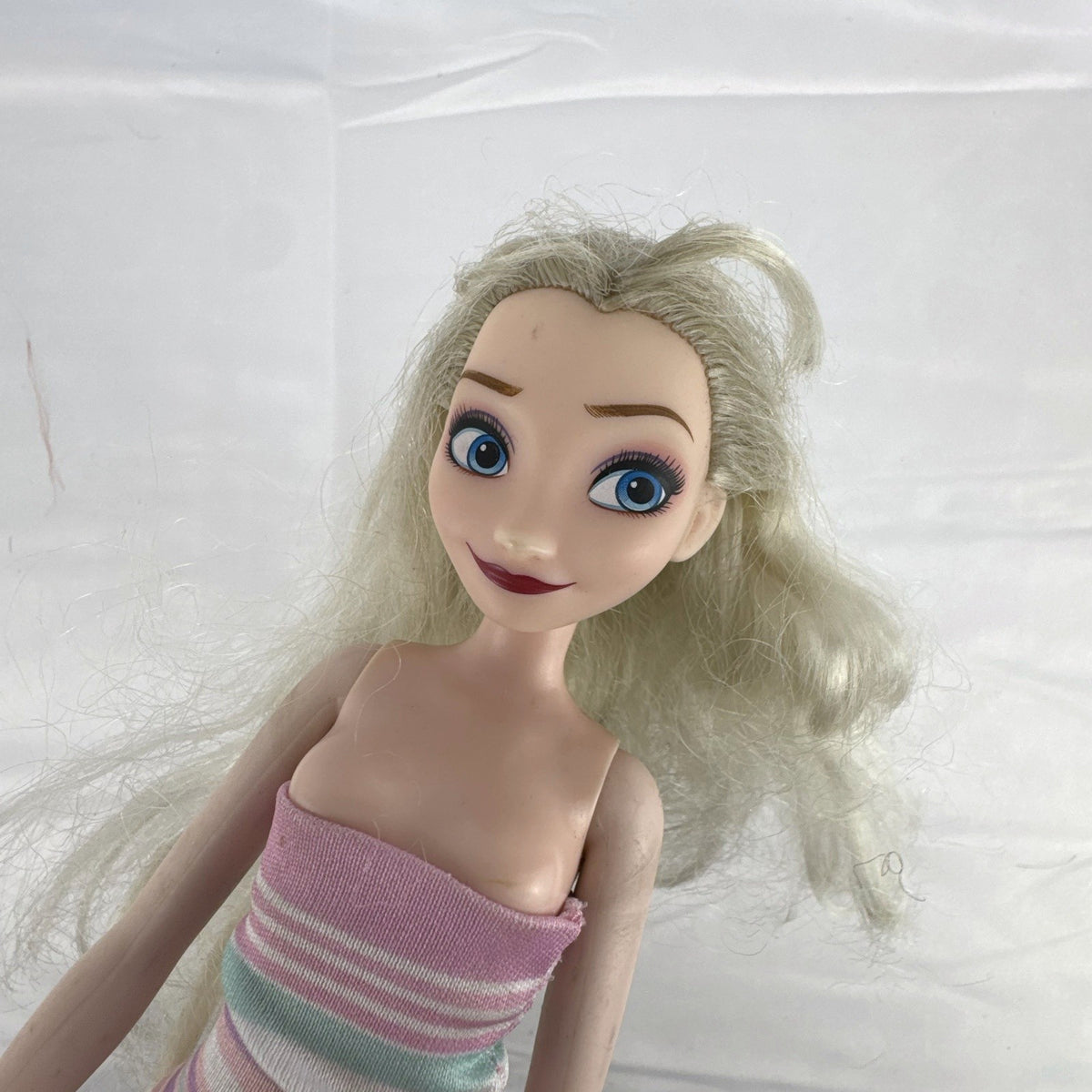 Disney Frozen Elsa 11-inch fashion doll with blonde hair wearing a pink striped heart dress