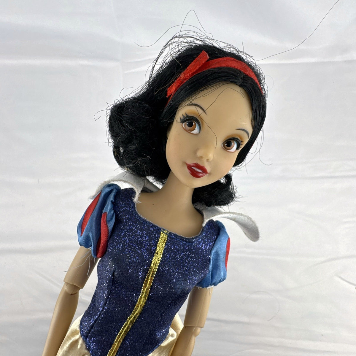 Disney Store Snow White 11.5-inch fashion doll in classic blue and yellow gown with articulated arms