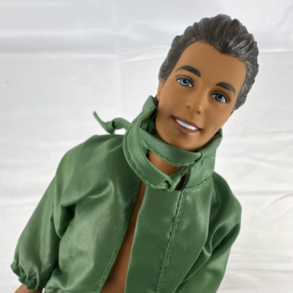 Mattel 12-inch Ken doll with molded brown hair wearing green jacket and blue swim board shorts