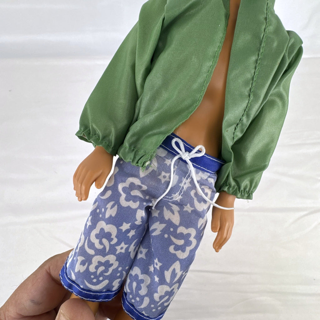 Mattel 12-inch Ken doll with molded brown hair wearing green jacket and blue swim board shorts