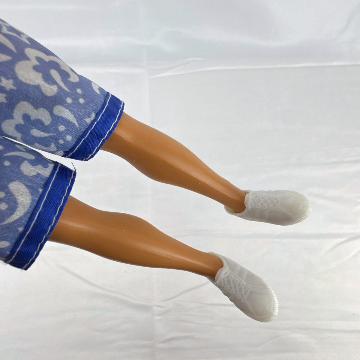 Mattel 12-inch Ken doll with molded brown hair wearing green jacket and blue swim board shorts
