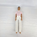 Mattel Barbie Ken 12-inch fashion doll with molded brown hair wearing a pink shirt with suspenders and white pants.