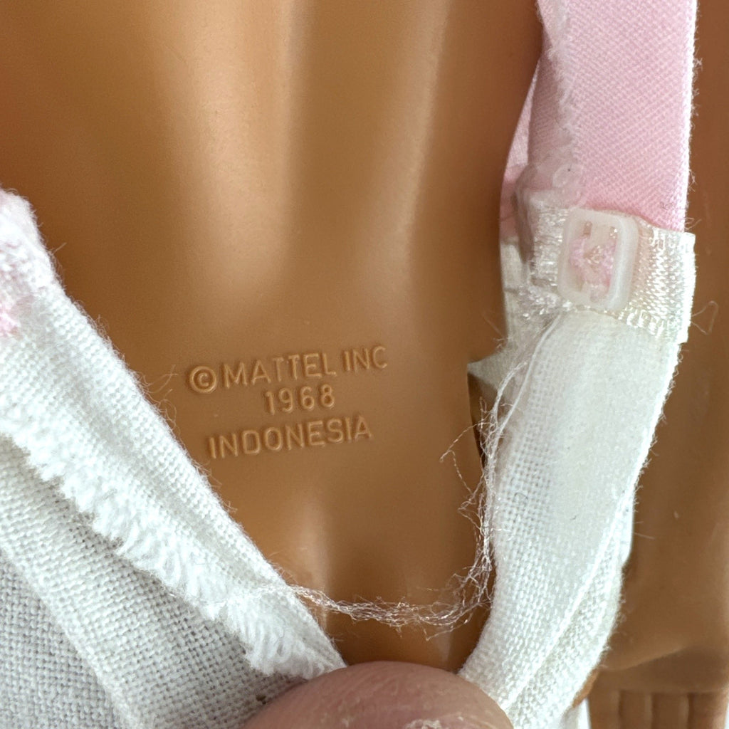 Mattel Barbie Ken 12-inch fashion doll with molded brown hair wearing a pink shirt with suspenders and white pants.