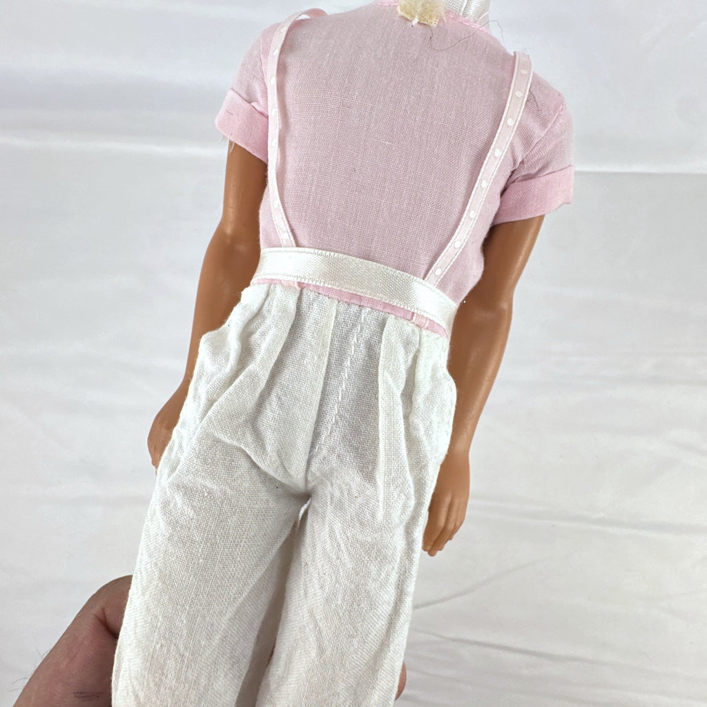 Mattel Barbie Ken 12-inch fashion doll with molded brown hair wearing a pink shirt with suspenders and white pants.