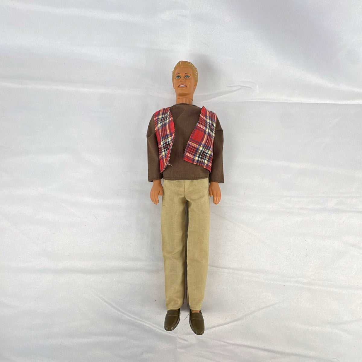Vintage 1991 Mattel Ken doll with molded blonde hair wearing a red plaid vest outfit and brown shoes