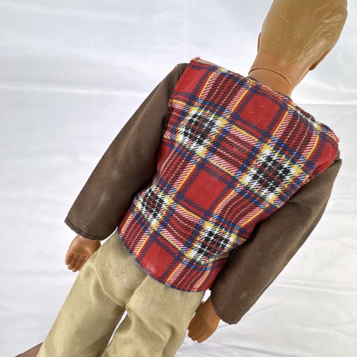Vintage 1991 Mattel Ken doll with molded blonde hair wearing a red plaid vest outfit and brown shoes