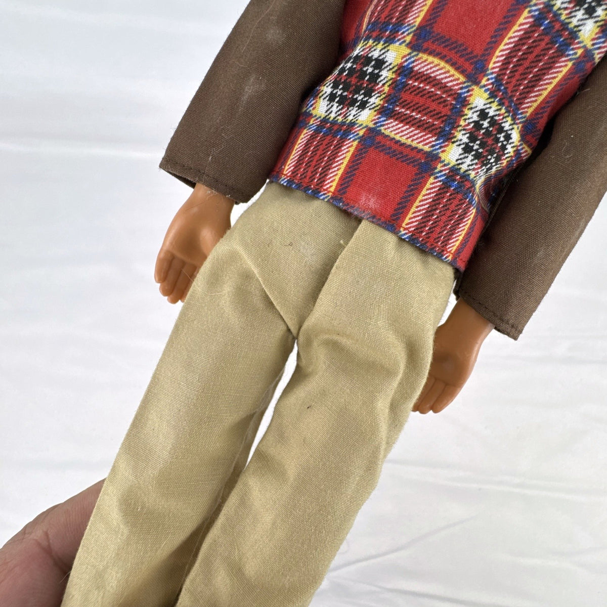 Vintage 1991 Mattel Ken doll with molded blonde hair wearing a red plaid vest outfit and brown shoes