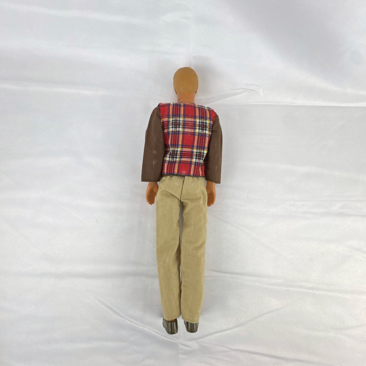 Vintage 1991 Mattel Ken doll with molded blonde hair wearing a red plaid vest outfit and brown shoes