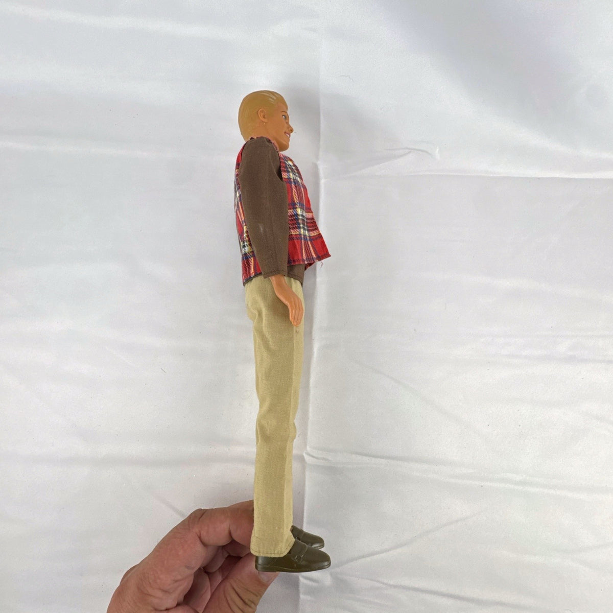 Vintage 1991 Mattel Ken doll with molded blonde hair wearing a red plaid vest outfit and brown shoes