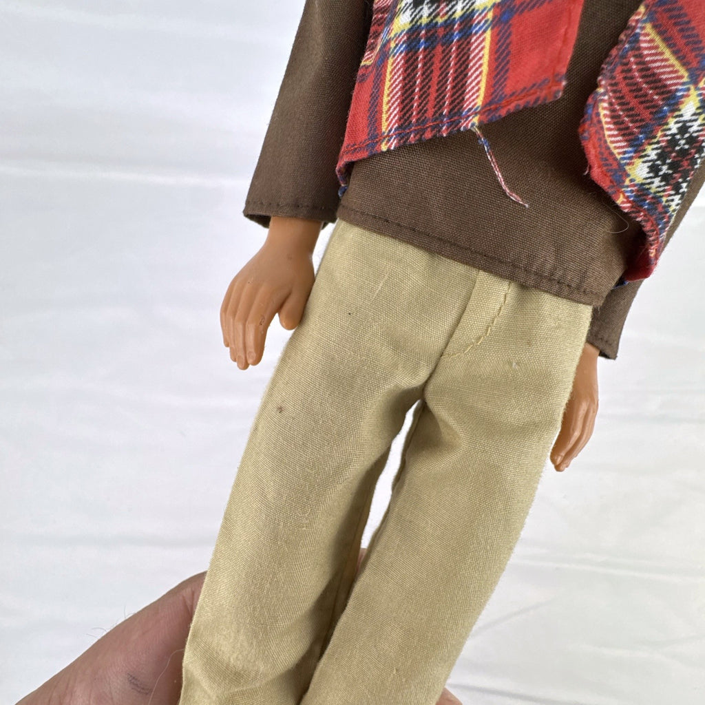 Vintage 1991 Mattel Ken doll with molded blonde hair wearing a red plaid vest outfit and brown shoes