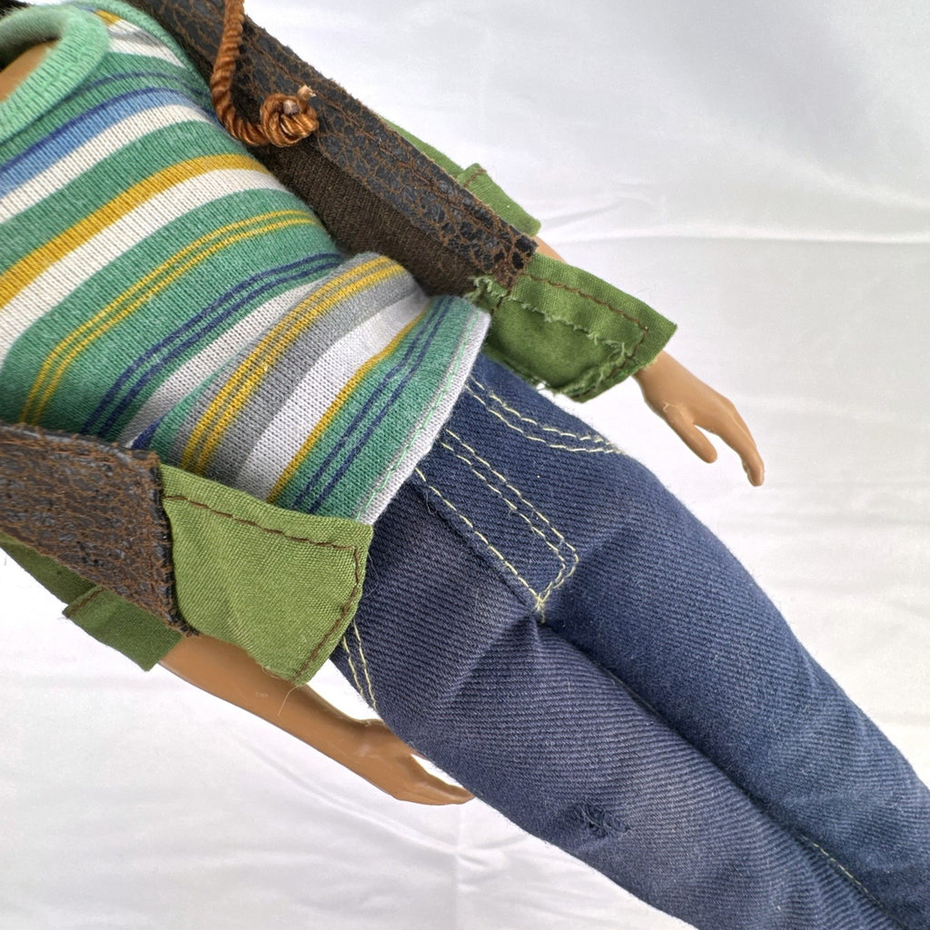 Mattel 2009 Ken 12-inch fashion doll with rooted blonde hair wearing a layered jacket and denim pants