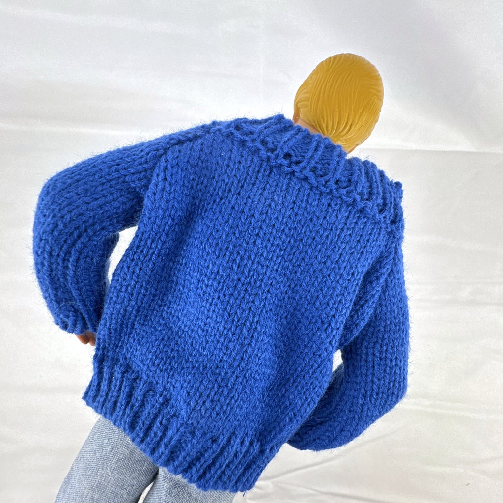 Vintage Mattel Ken doll in blue knit reindeer Christmas sweater, gray pants, and red shoes