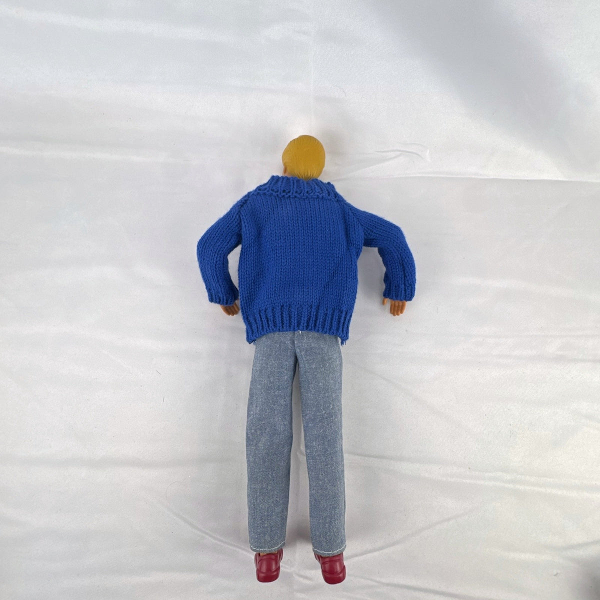 Vintage Mattel Ken doll in blue knit reindeer Christmas sweater, gray pants, and red shoes