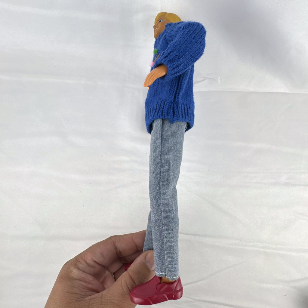 Vintage Mattel Ken doll in blue knit reindeer Christmas sweater, gray pants, and red shoes