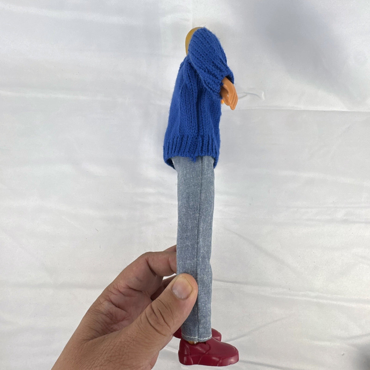 Vintage Mattel Ken doll in blue knit reindeer Christmas sweater, gray pants, and red shoes