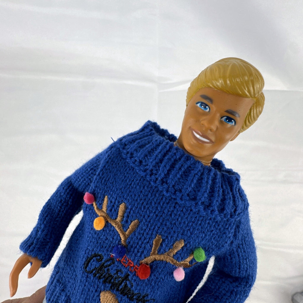 Vintage Mattel Ken doll in blue knit reindeer Christmas sweater, gray pants, and red shoes