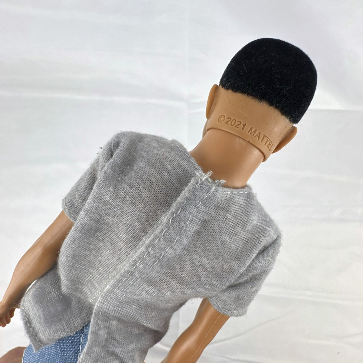 Mattel Ken 12-inch slim fashion doll wearing a colorblock pocket t-shirt and denim shorts