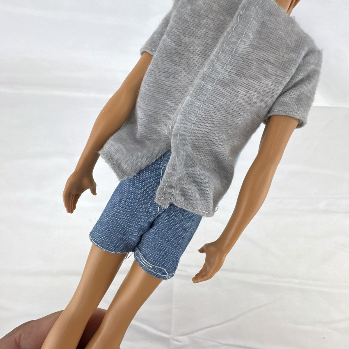 Mattel Ken 12-inch slim fashion doll wearing a colorblock pocket t-shirt and denim shorts
