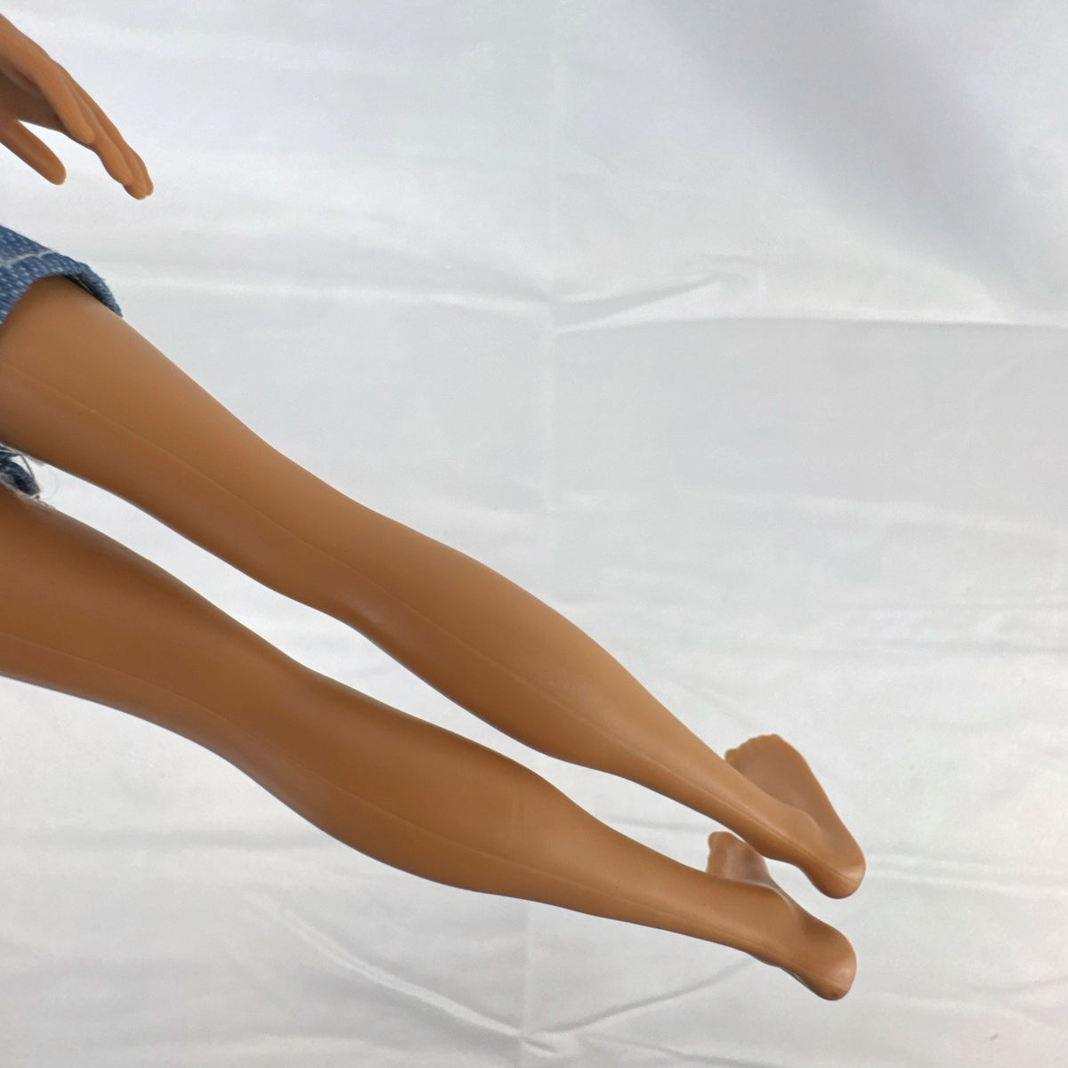 Mattel Ken 12-inch slim fashion doll wearing a colorblock pocket t-shirt and denim shorts