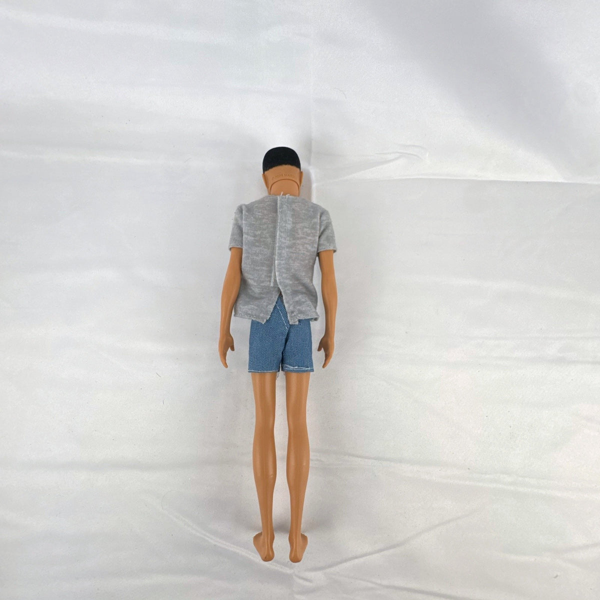 Mattel Ken 12-inch slim fashion doll wearing a colorblock pocket t-shirt and denim shorts