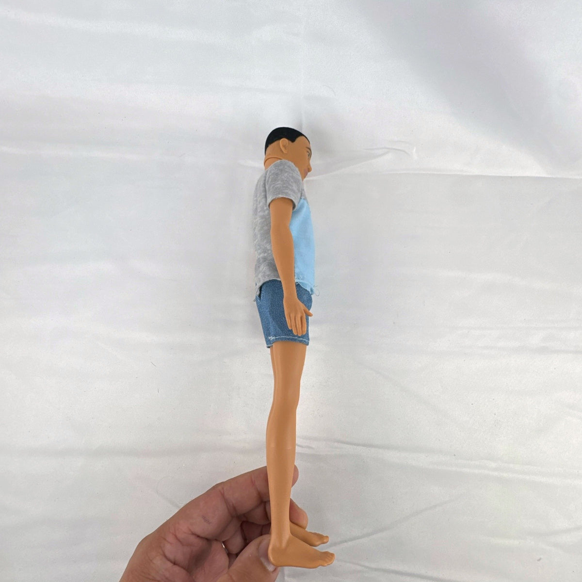 Mattel Ken 12-inch slim fashion doll wearing a colorblock pocket t-shirt and denim shorts