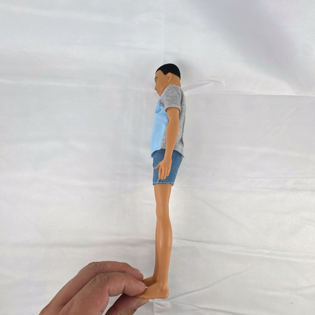 Mattel Ken 12-inch slim fashion doll wearing a colorblock pocket t-shirt and denim shorts
