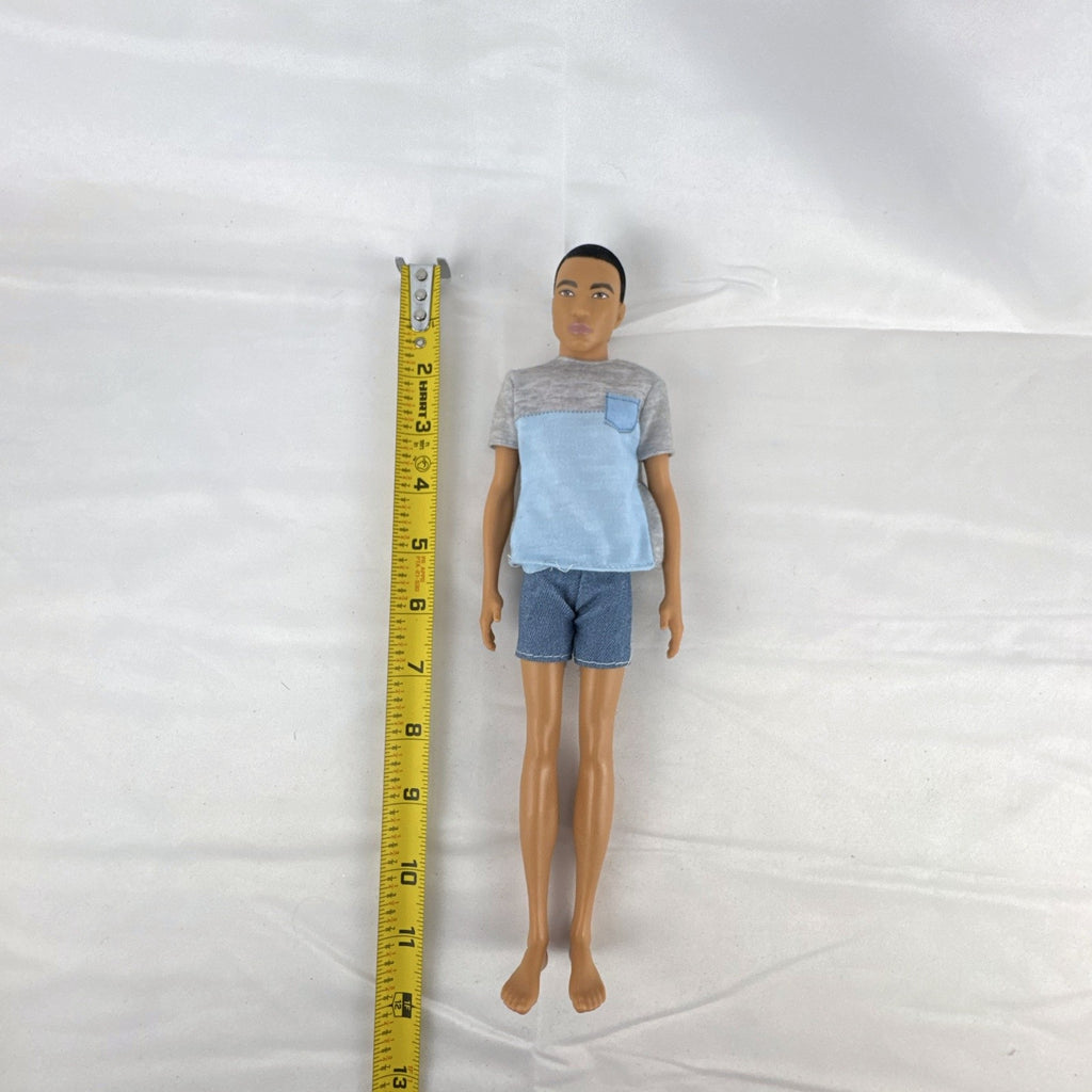 Mattel Ken 12-inch slim fashion doll wearing a colorblock pocket t-shirt and denim shorts
