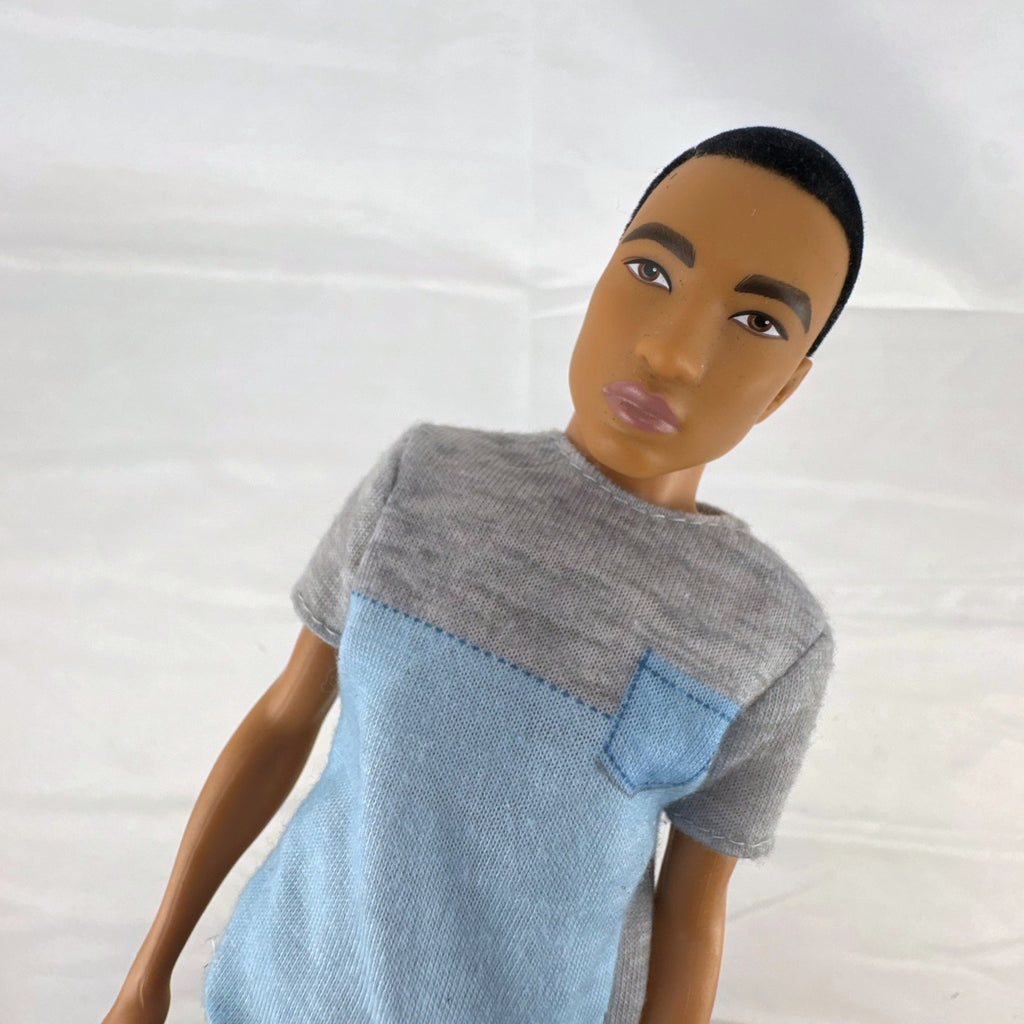Mattel Ken 12-inch slim fashion doll wearing a colorblock pocket t-shirt and denim shorts