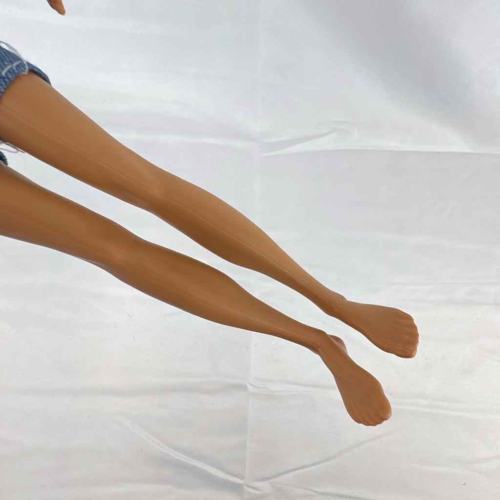 Mattel Ken 12-inch slim fashion doll wearing a colorblock pocket t-shirt and denim shorts